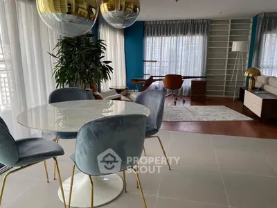 Modern open-plan living room with stylish dining area and study corner