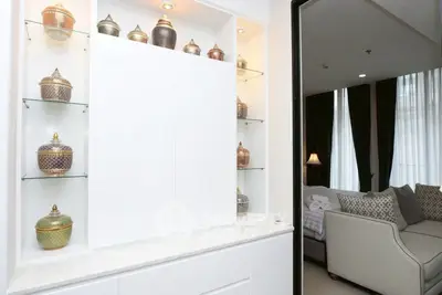 Elegant living room with decorative shelves and cozy seating area