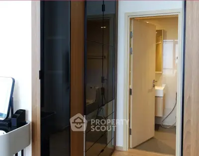 Modern apartment interior with sleek bathroom and stylish closet design.
