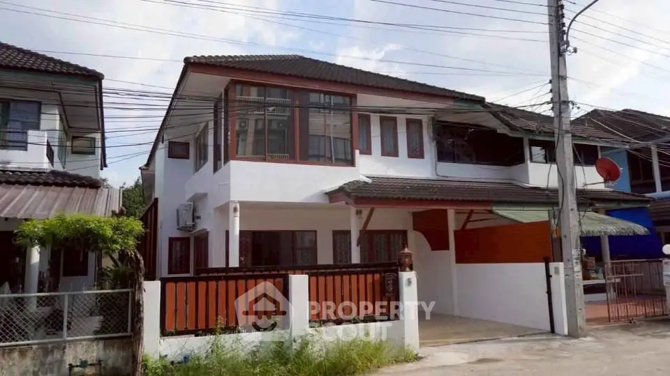 Charming two-story house with modern design and spacious driveway in a serene neighborhood.
