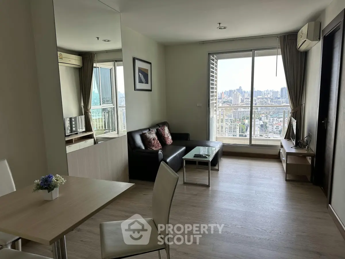 Modern living room with city view, sleek furniture, and natural light.
