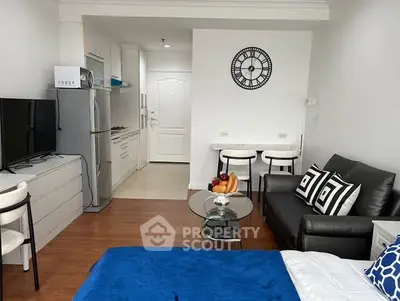 Modern studio apartment with stylish decor and compact kitchen