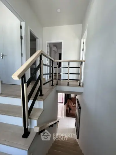 Modern staircase with sleek railing in contemporary home interior
