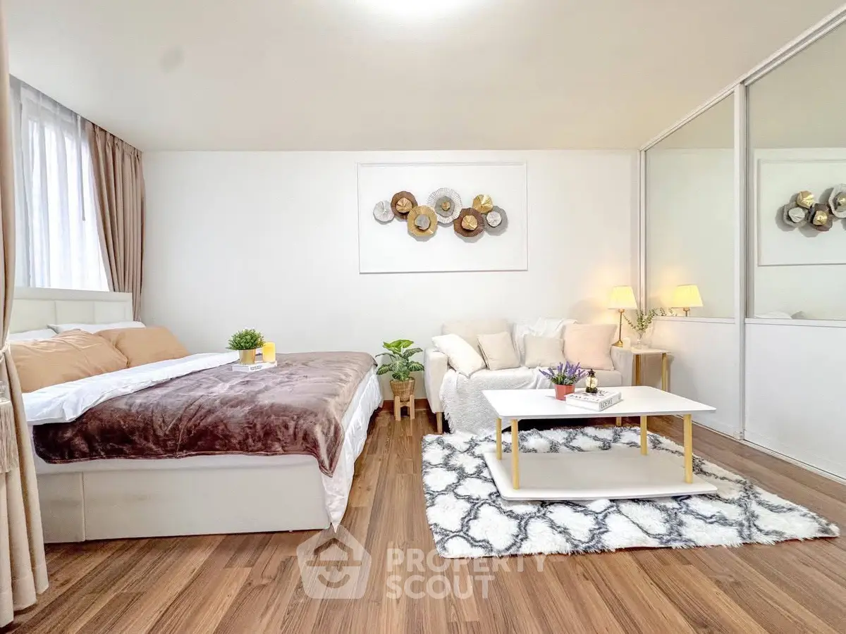 Spacious modern bedroom with cozy seating area and stylish decor