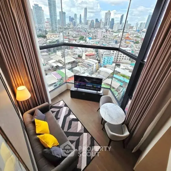 Stunning high-rise living room with panoramic city views and modern decor.