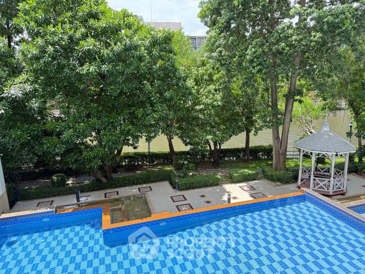 Luxurious poolside view with lush greenery and charming gazebo