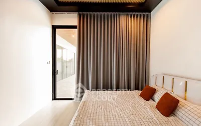 Modern bedroom with large window and stylish curtains, featuring a cozy bed with accent pillows.