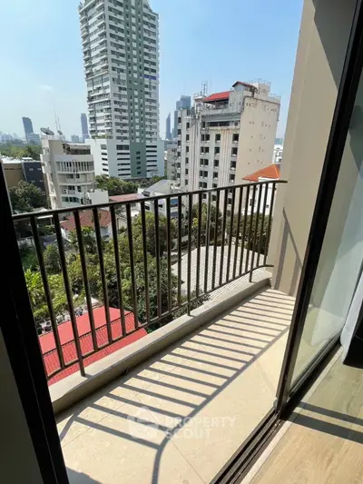 Spacious balcony with city view in modern high-rise apartment