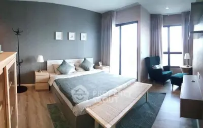 Spacious modern bedroom with large windows and stylish decor