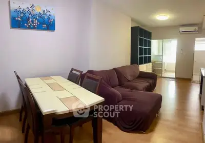 Cozy living room with dining area and modern decor in a stylish apartment.
