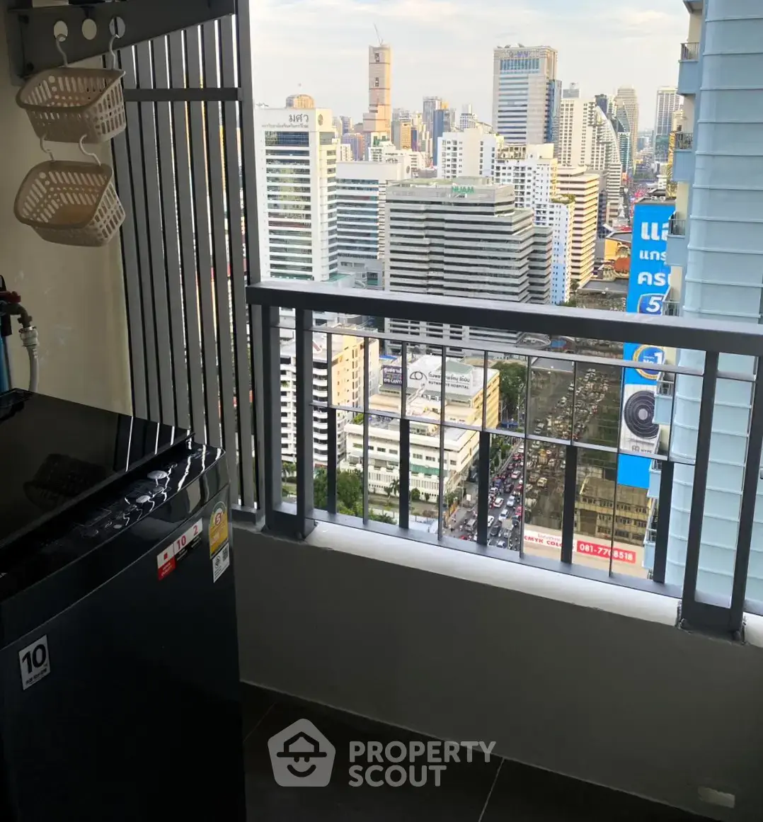 High-rise balcony with stunning cityscape view and modern appliances.