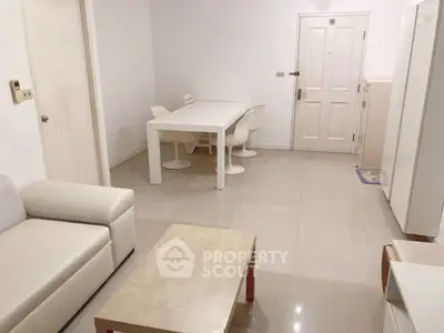 Spacious modern living room with sleek white furniture and minimalist design