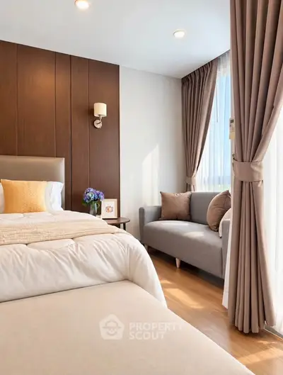 Elegant bedroom with cozy seating area and natural light