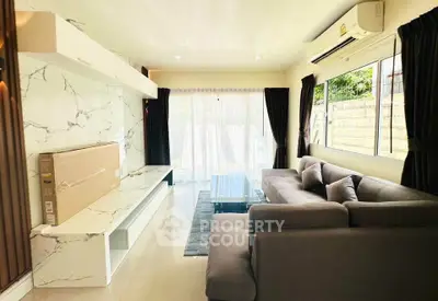 Spacious living room with modern decor and large windows for natural light.