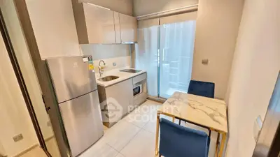 Modern compact kitchen with dining area and balcony access