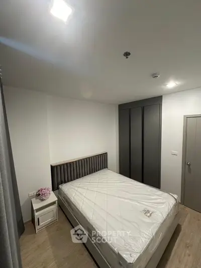 Modern bedroom with sleek wardrobe and cozy bed in minimalist design