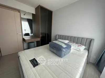 Modern bedroom with stylish furniture and natural light, featuring a comfortable bed and sleek wardrobe.