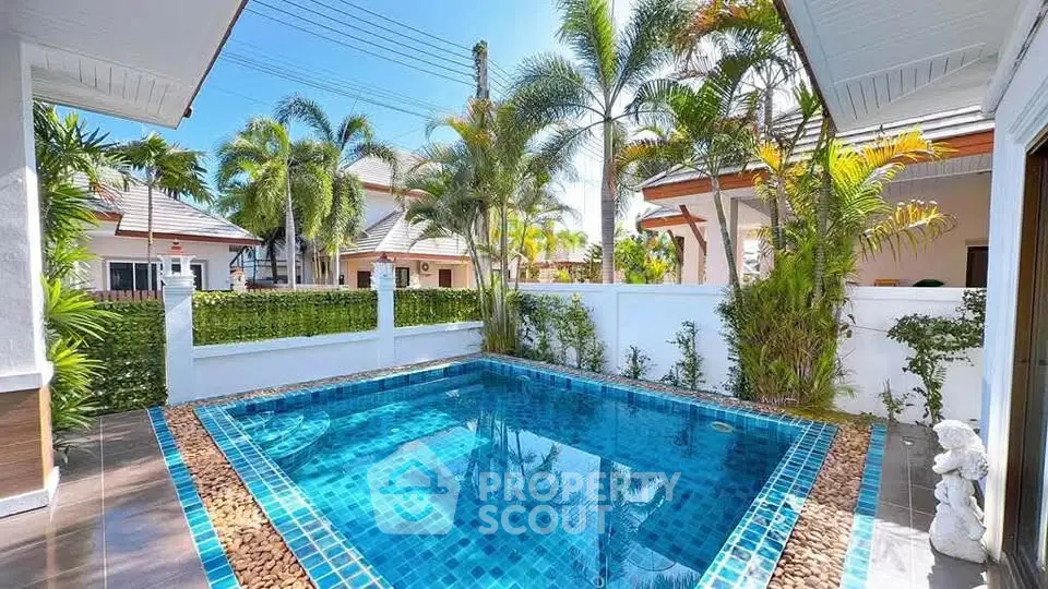 Stunning private pool in tropical villa with lush garden and modern design.