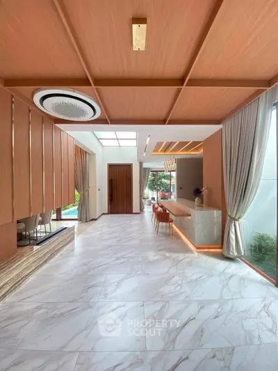 Luxurious modern living room with marble flooring and elegant wooden ceiling design.