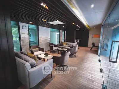 Modern lounge area with stylish seating and wooden accents, perfect for relaxation and social gatherings.