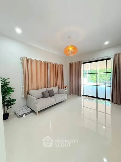 Spacious living room with modern decor and large windows for natural light.