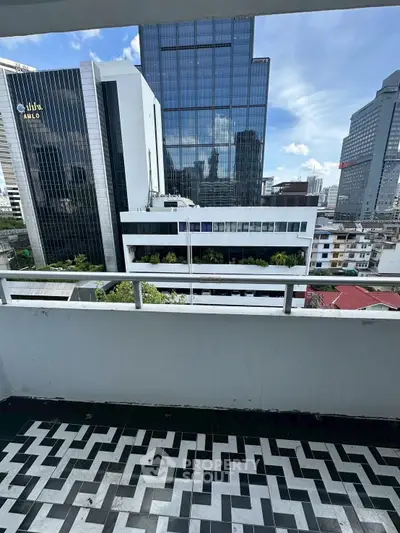 Stunning cityscape view from a modern balcony with unique patterned flooring, perfect for urban living.