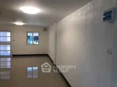 Spacious unfurnished room with tiled flooring and bright lighting, ideal for customization.