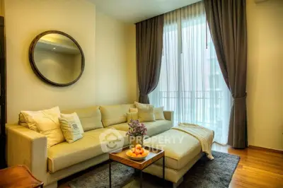 Elegant living room with cozy beige sofa, stylish decor, and large window with curtains.