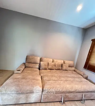 Spacious living room with a large, comfortable sofa and modern decor.