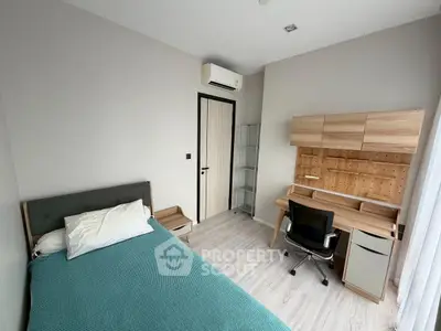 Modern bedroom with sleek desk and comfortable bed, perfect for productivity and relaxation.