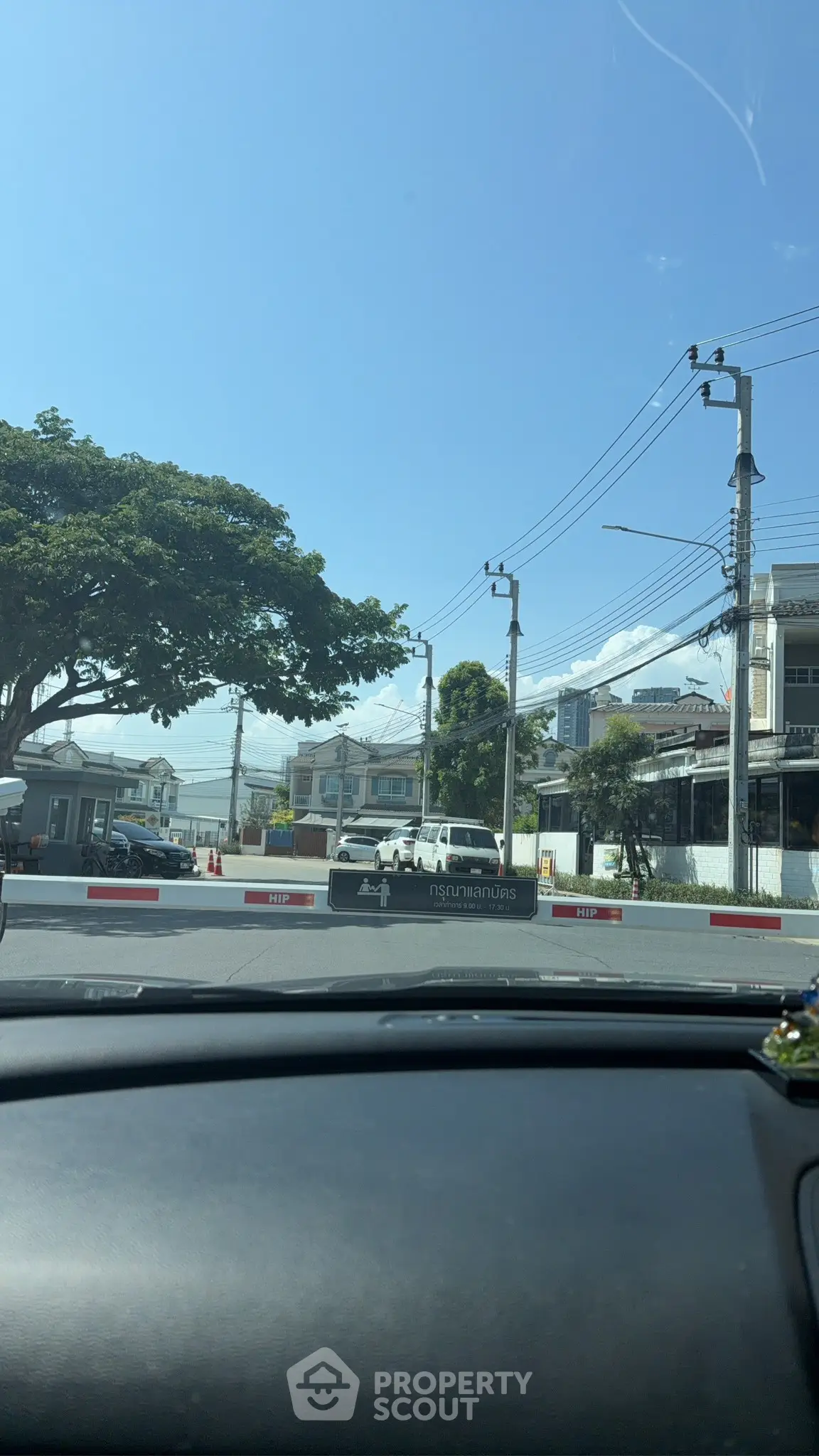 Scenic view of a residential neighborhood with clear blue skies and lush greenery.