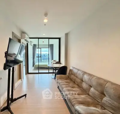 Modern living room with sleek design and city view, featuring a cozy sofa and wall-mounted TV.