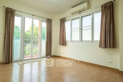 Spacious empty room with balcony and large windows, perfect for natural light.