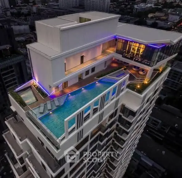 Luxurious high-rise building with rooftop pool and stunning city views, perfect for upscale urban living.