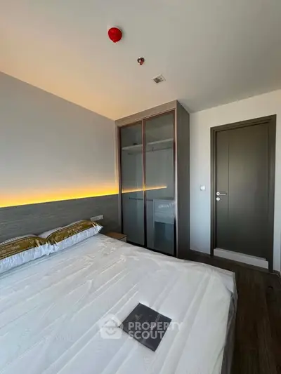Modern bedroom with sleek wardrobe and ambient lighting, perfect for a cozy retreat.