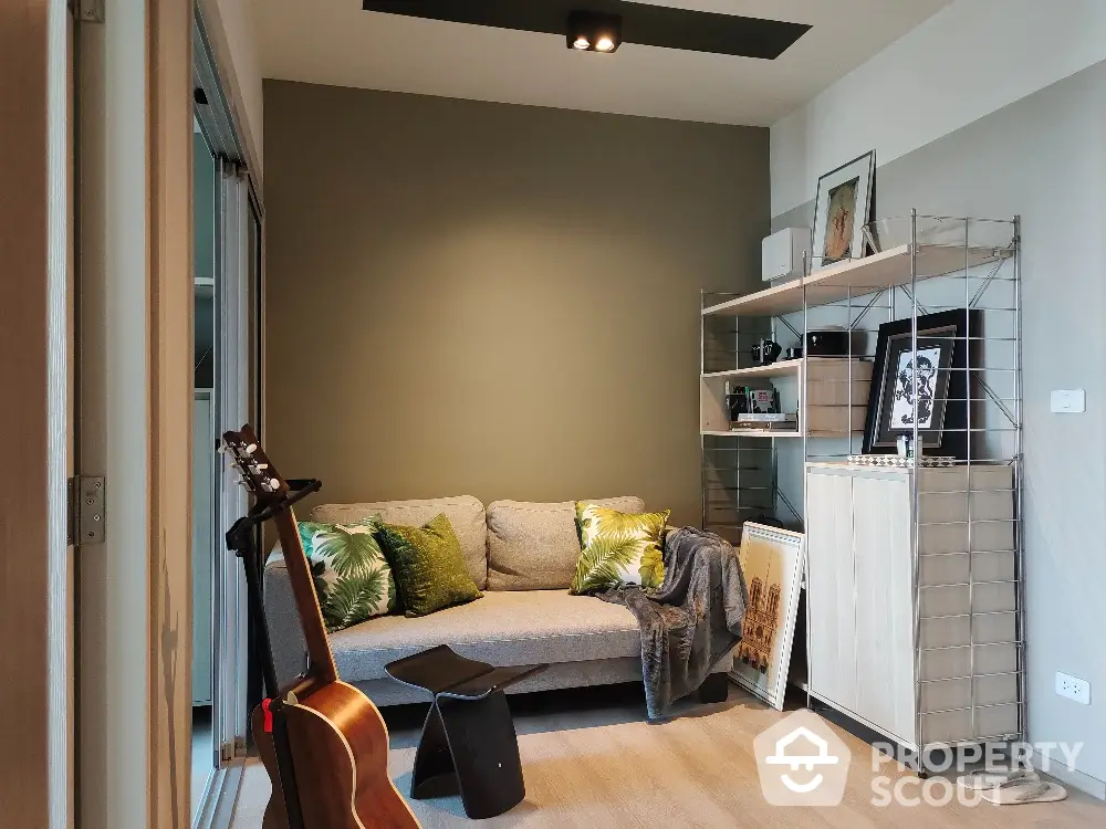 Cozy living room with modern decor and guitar, perfect for relaxation.