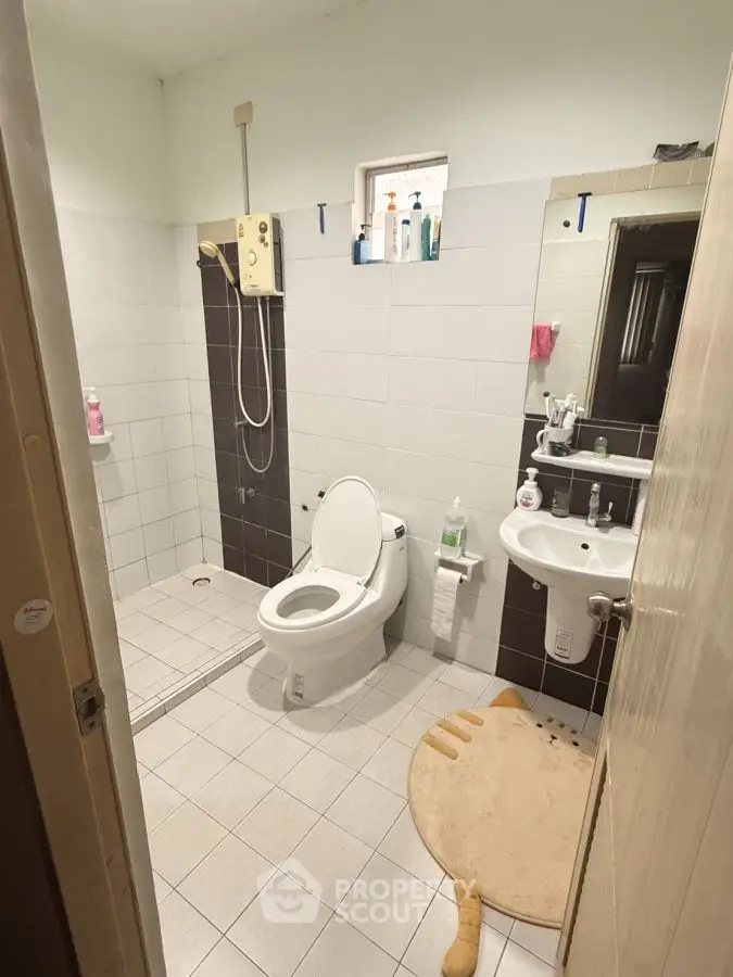 Cozy bathroom with shower and modern fixtures, ideal for compact spaces.