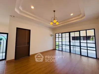 Spacious modern living room with elegant lighting and large windows