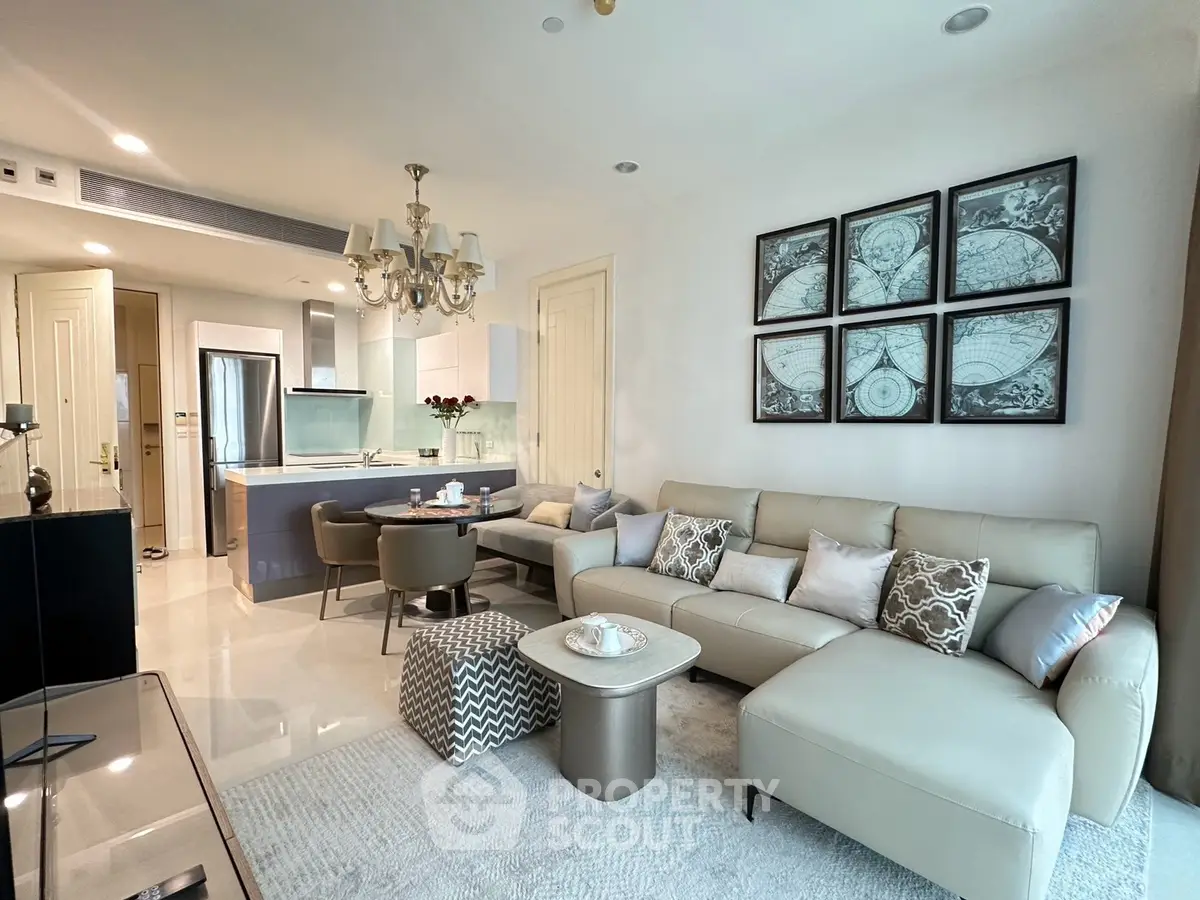 Luxurious open-plan living room with elegant decor and modern kitchen in upscale apartment.