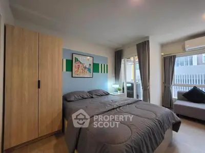 Modern bedroom with cozy decor and natural light, featuring a comfortable bed and stylish wardrobe.
