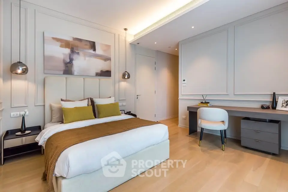 Luxurious modern bedroom with elegant decor and workspace, featuring stylish lighting and cozy ambiance.