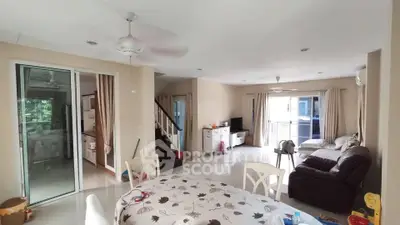 Spacious living room with modern decor and large windows for natural light.