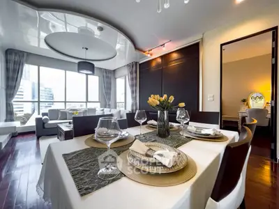 Luxurious dining area with elegant table setting and spacious living room view in modern apartment.