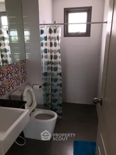 Cozy bathroom with modern fixtures and colorful shower curtain