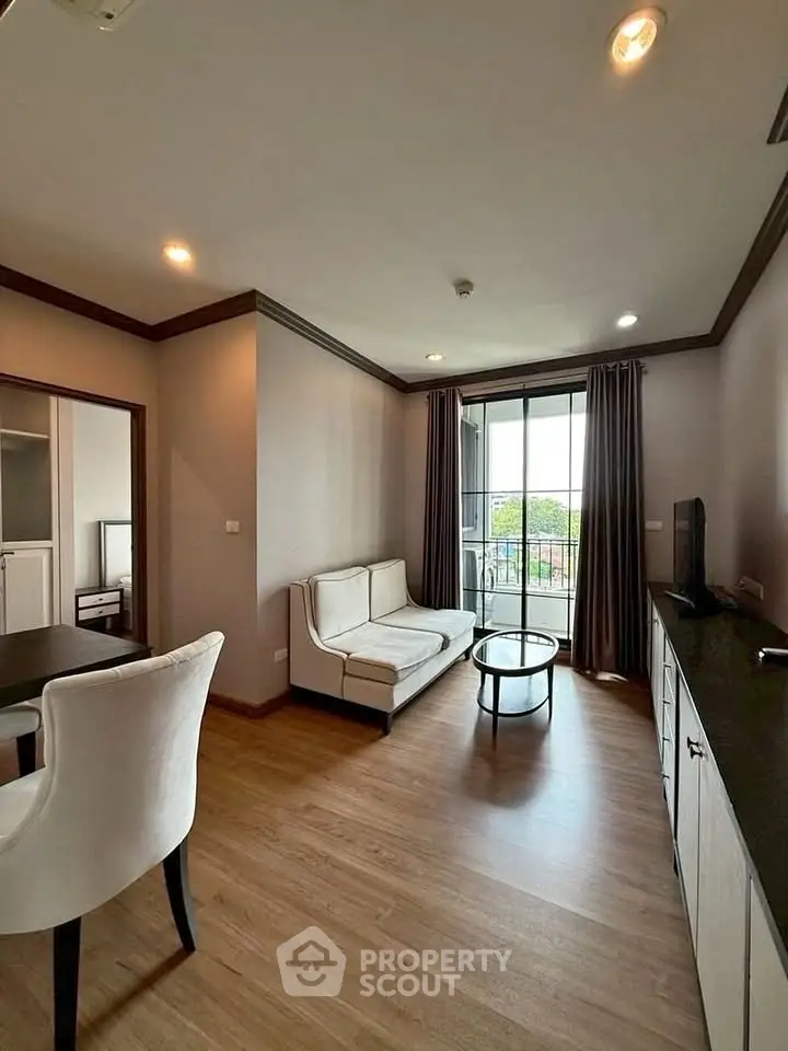 Modern living room with elegant furniture and balcony view in a stylish apartment.