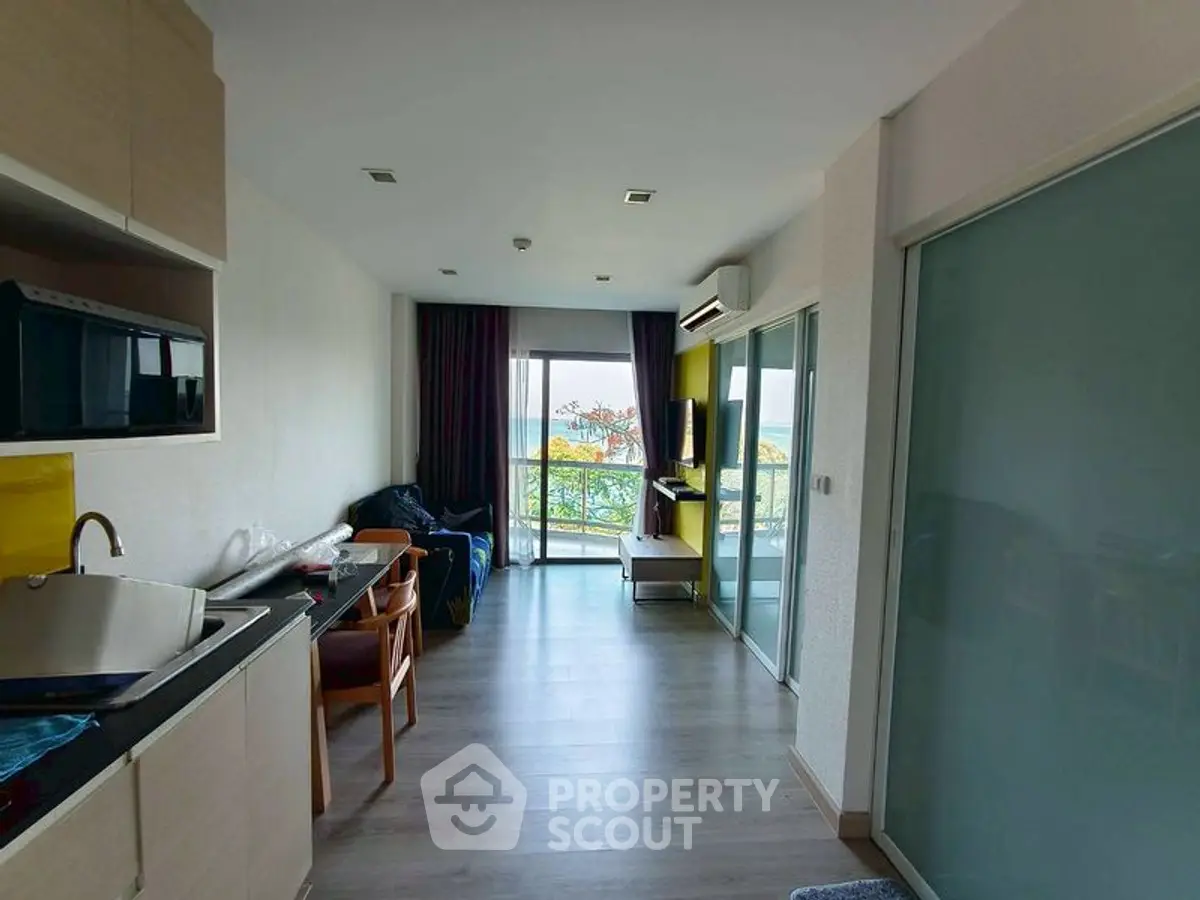 Modern living room with open kitchen and balcony view