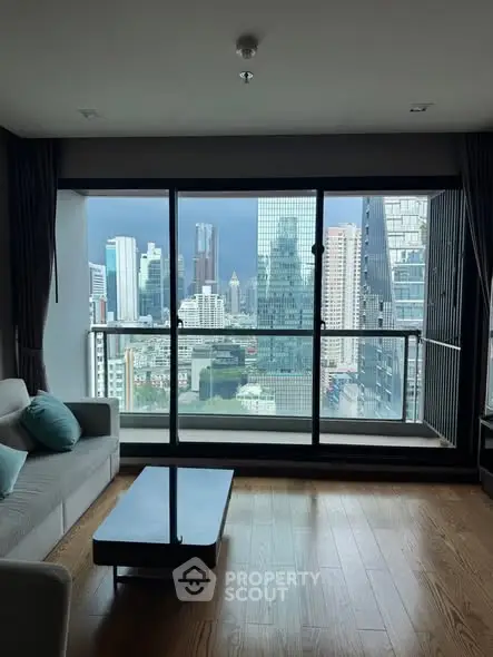 Stunning city view from modern living room with floor-to-ceiling windows and elegant decor.