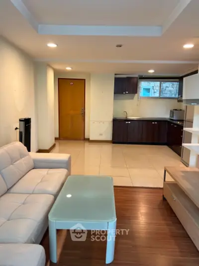 Modern open-layout living room with sleek kitchen and cozy seating area