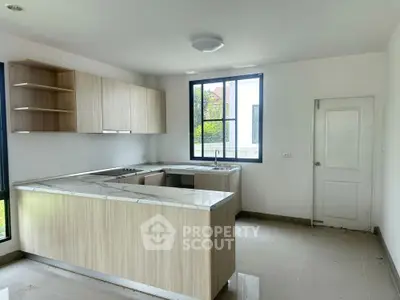 Modern kitchen with marble countertops and natural light
