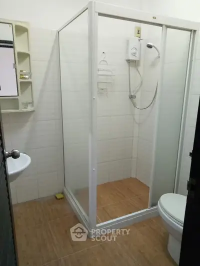 Modern bathroom with glass shower enclosure and sleek fixtures